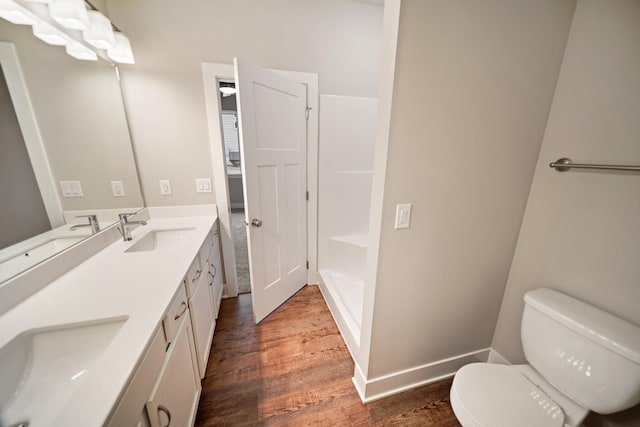 bathroom with vanity, toilet, and hardwood / wood-style floors