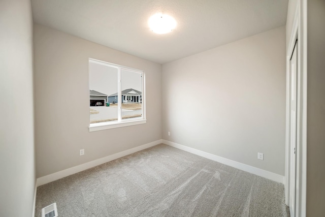 unfurnished room with carpet floors