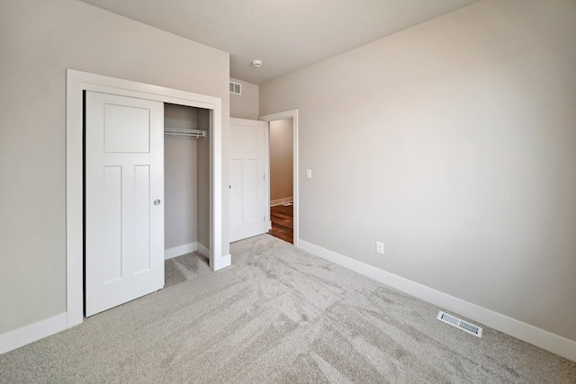 unfurnished bedroom featuring carpet floors and a closet