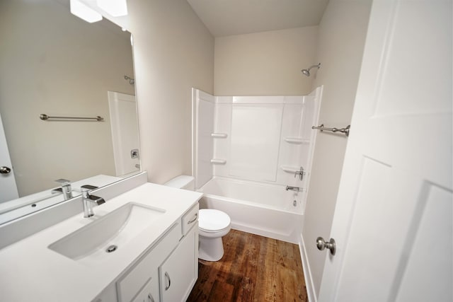 full bathroom featuring hardwood / wood-style flooring, shower / washtub combination, vanity, and toilet