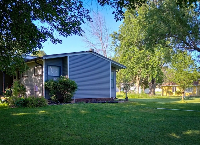 view of property exterior featuring a lawn