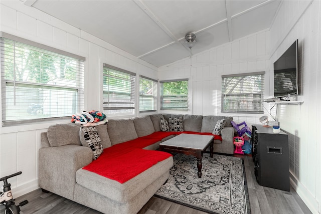 living room with a wealth of natural light, vaulted ceiling, and wood-type flooring