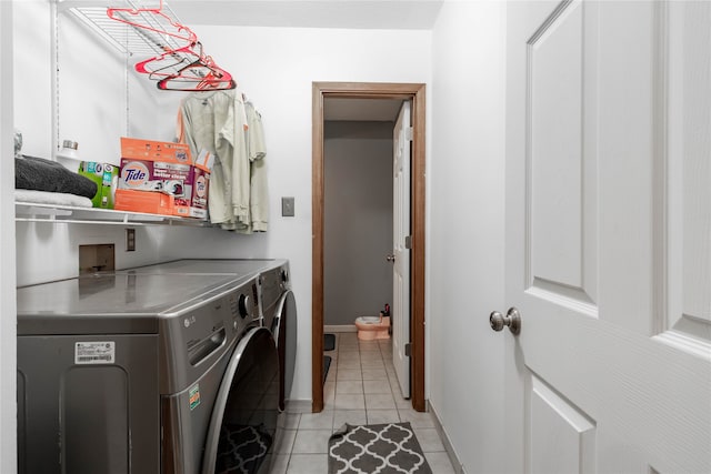 laundry room with light tile patterned flooring and washer and dryer