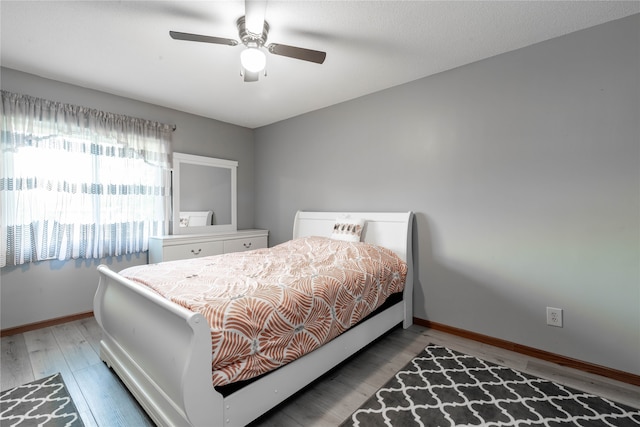 bedroom with hardwood / wood-style floors and ceiling fan