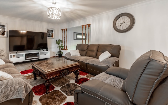 living room with ornamental molding, hardwood / wood-style floors, and a chandelier