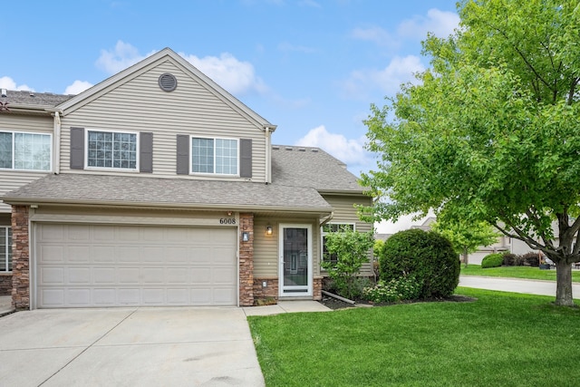 view of front facade with a front lawn and a garage