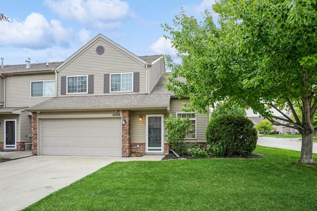 view of front of house with a front lawn and a garage