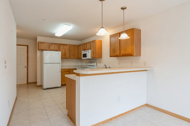 kitchen with decorative light fixtures, white appliances, light tile patterned flooring, and kitchen peninsula