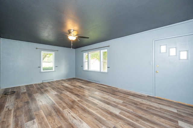 foyer featuring a textured ceiling, ceiling fan, and hardwood / wood-style flooring