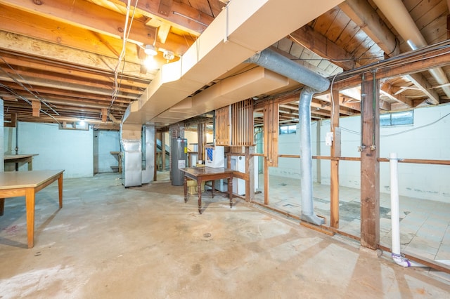 basement featuring water heater and heating unit