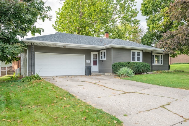 ranch-style house featuring a front yard and a garage