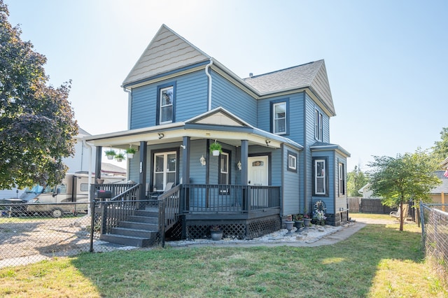 view of front of house with a front yard and covered porch