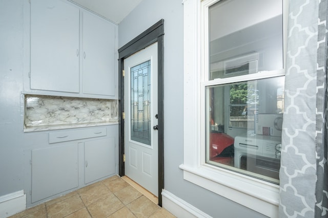 interior space with tasteful backsplash and light tile patterned floors