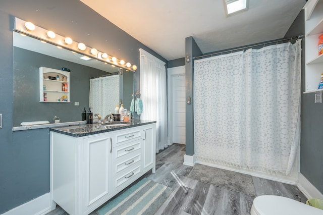 bathroom featuring vanity, hardwood / wood-style floors, curtained shower, and toilet