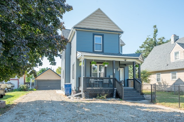 view of front of home featuring a porch, an outbuilding, and a garage