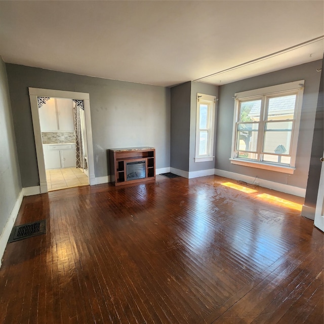 unfurnished living room featuring hardwood / wood-style flooring and a fireplace