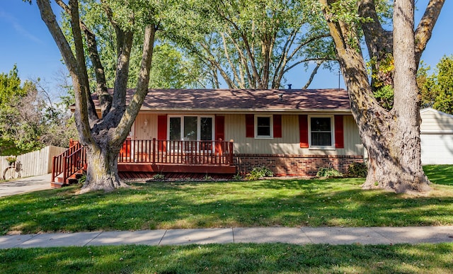 ranch-style house with a front yard and a deck