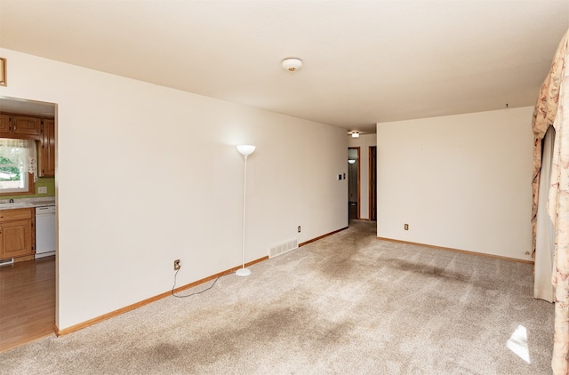 unfurnished room featuring carpet and a fireplace