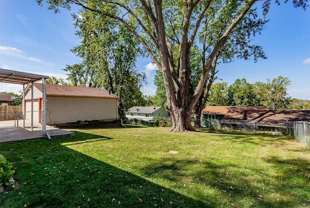 view of yard featuring an outbuilding and a garage