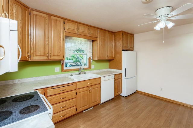 kitchen with white appliances, light hardwood / wood-style floors, sink, and ceiling fan