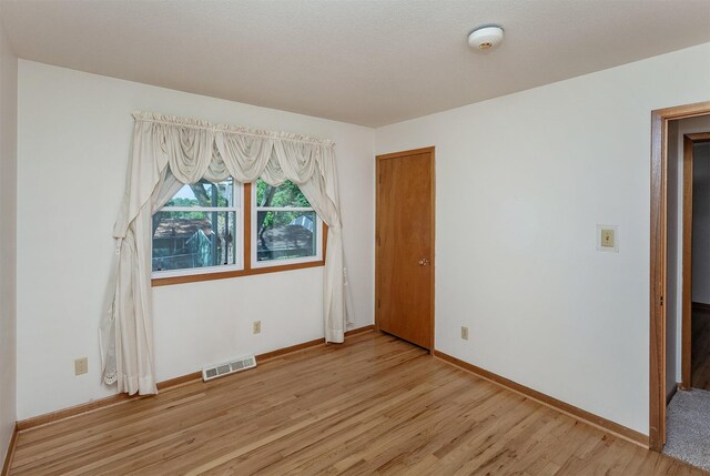 spare room featuring light wood-type flooring