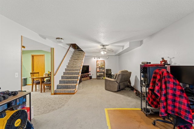 carpeted office with ceiling fan and a textured ceiling