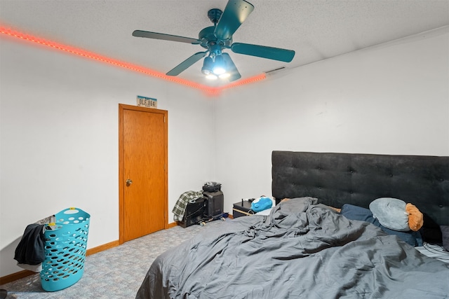 bedroom with carpet floors, a textured ceiling, and ceiling fan