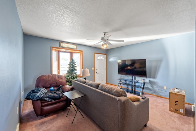 carpeted living room featuring ceiling fan and a textured ceiling