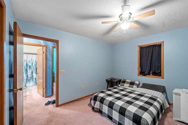 carpeted bedroom with radiator heating unit, a textured ceiling, and ceiling fan