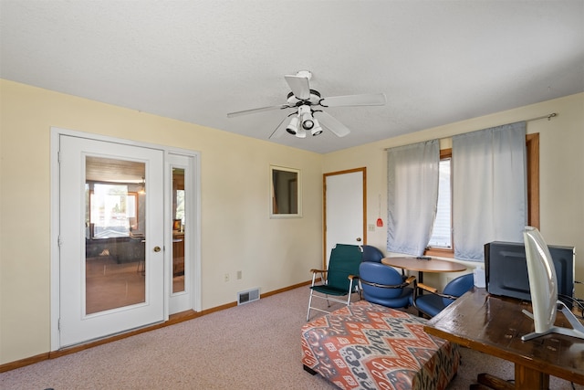 interior space with carpet floors and ceiling fan