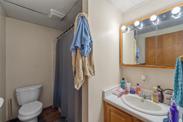 bathroom featuring wood-type flooring, vanity, and toilet