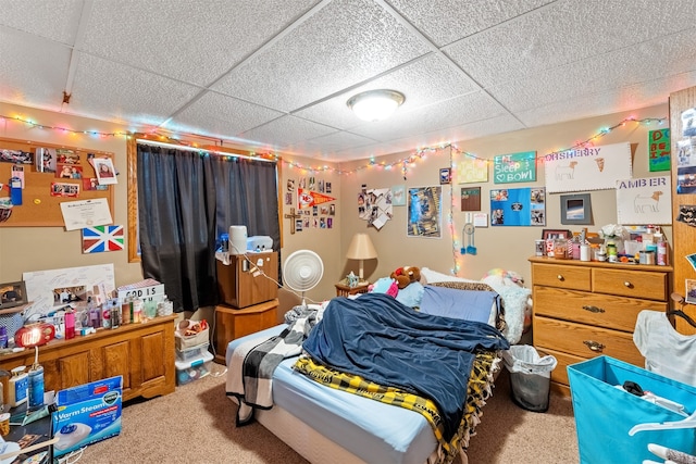 bedroom with a paneled ceiling and carpet