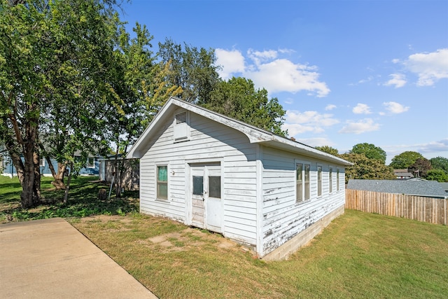 view of outbuilding featuring a yard