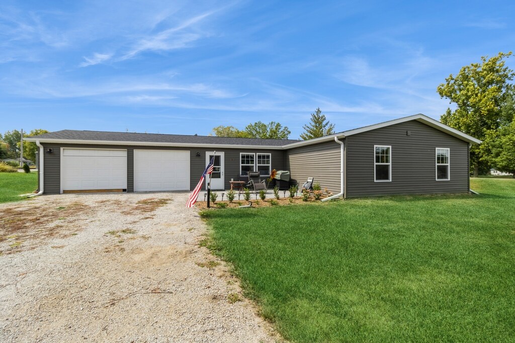 ranch-style home with a front yard and a garage