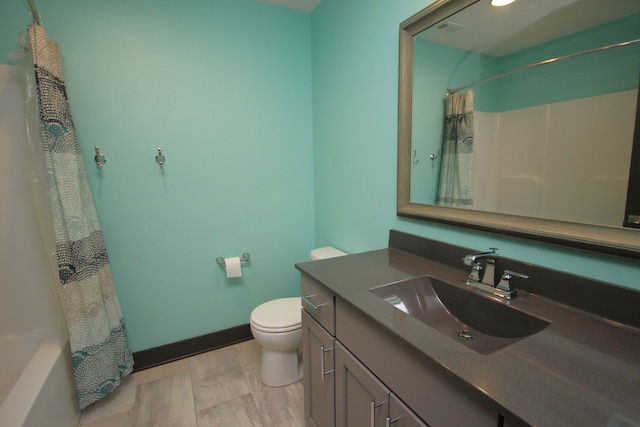 full bathroom with shower / bathtub combination with curtain, vanity, and toilet