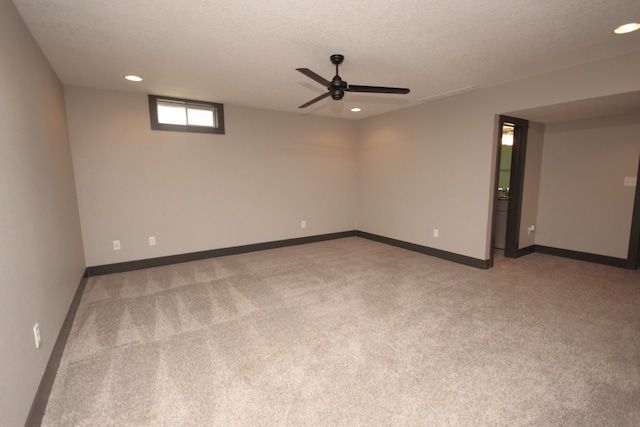 carpeted spare room with a textured ceiling and ceiling fan