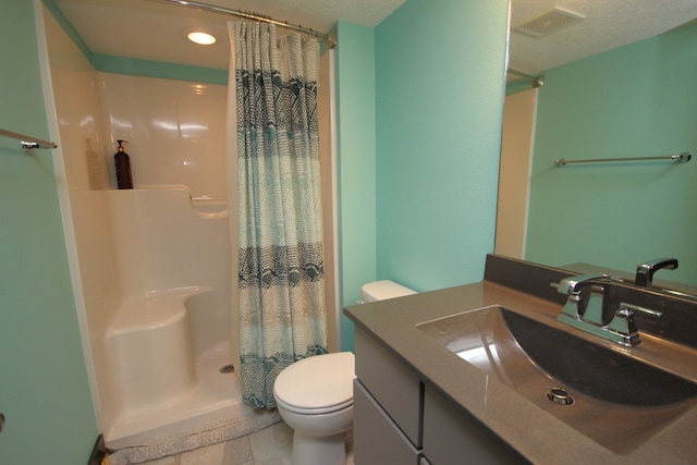 bathroom with vanity, a textured ceiling, a shower with shower curtain, toilet, and tile patterned floors