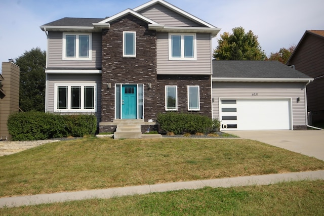 view of front of property with a front yard and a garage