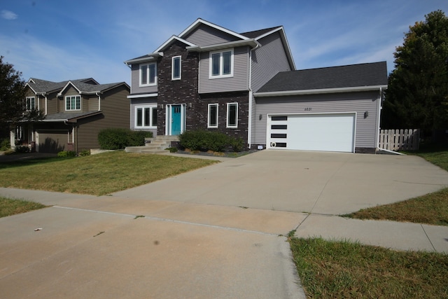 view of front facade with a front yard and a garage