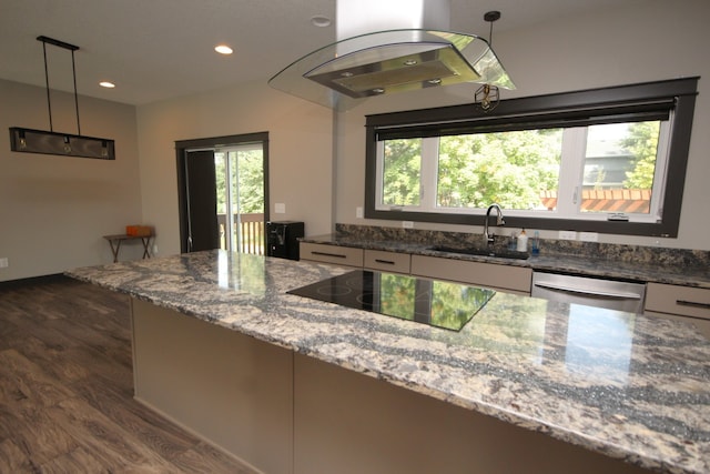 kitchen with hanging light fixtures, light stone countertops, dishwasher, and sink