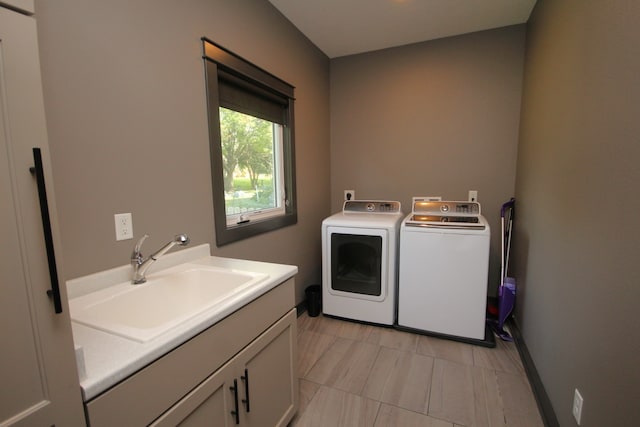 laundry room featuring washing machine and clothes dryer and sink