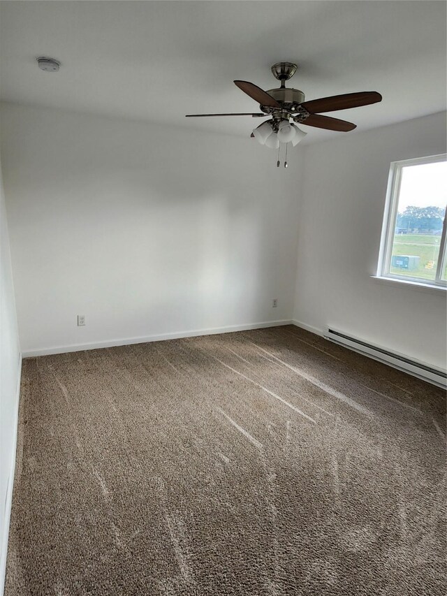 empty room with carpet floors, baseboard heating, and ceiling fan