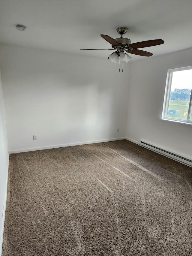 621/623 Burlington St, Harvey, IA 50119 - unfurnished room featuring baseboards, a baseboard heating unit, a ceiling fan, and carpet floors