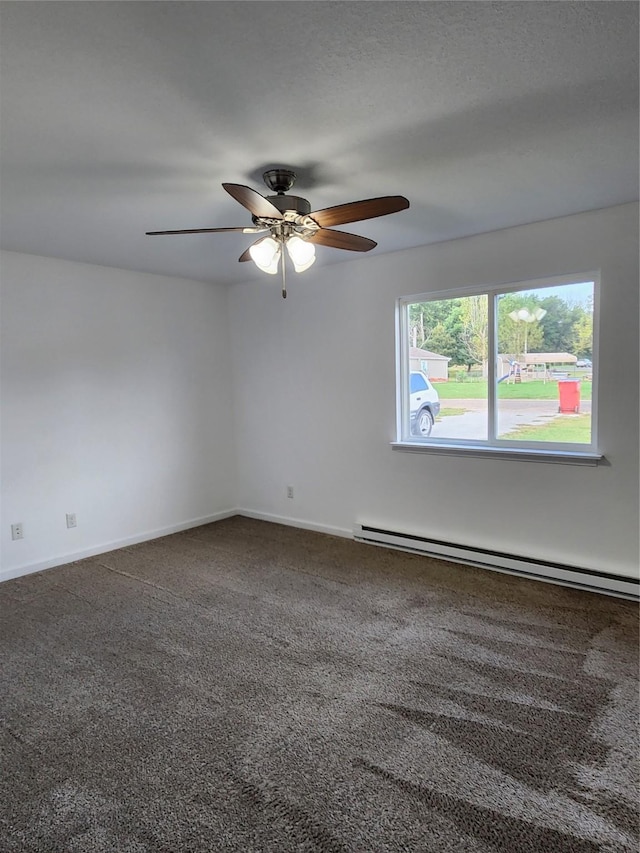 621/623 Burlington St, Harvey, IA 50119 - empty room with ceiling fan, carpet flooring, baseboards, and a baseboard radiator