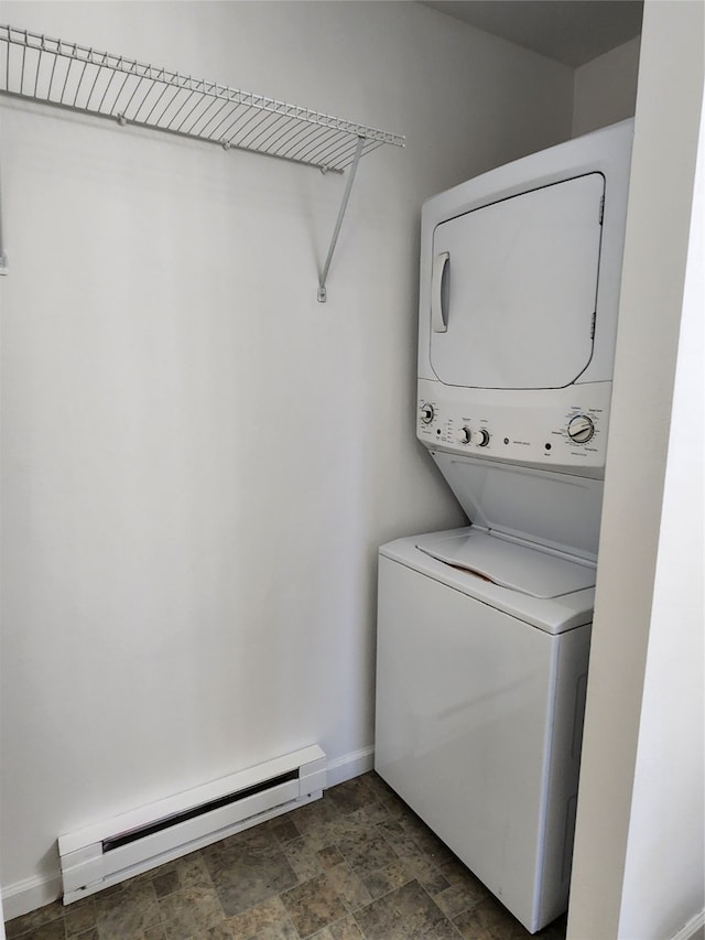 washroom with a baseboard radiator and stacked washer and dryer