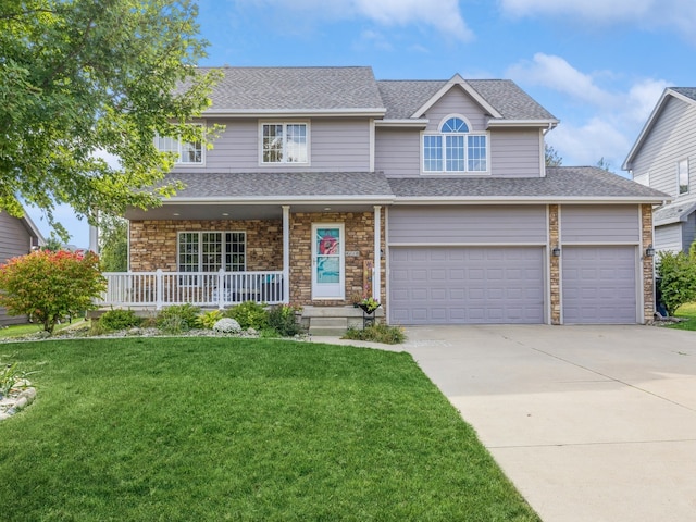 view of front facade featuring a garage, a front lawn, and covered porch