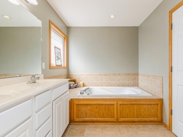 bathroom with vanity, tile patterned floors, and a tub