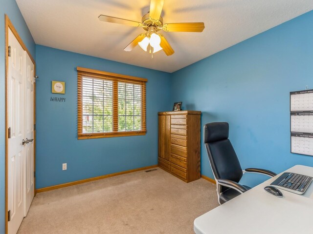 office area featuring light carpet and ceiling fan