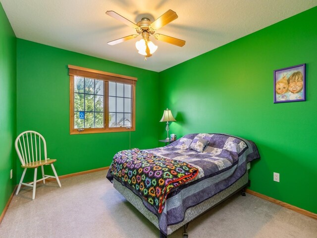 bedroom featuring ceiling fan and carpet flooring