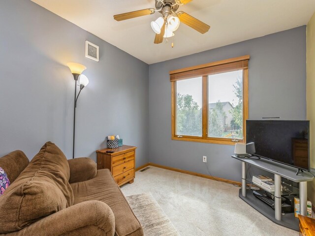 carpeted living room featuring ceiling fan